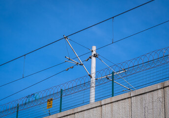 electric train energy cables and mast. razor safety mesh wires. 
