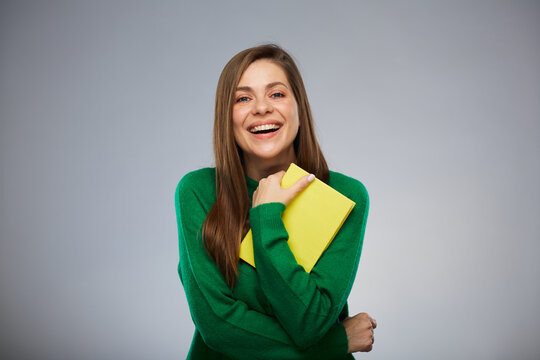 Happy woman teacher or student with yellow book. Isolated female portrait.