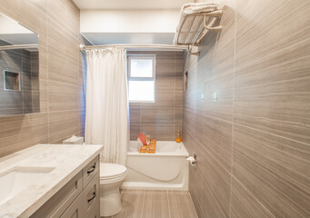 A Fancy Relaxing Spa Like Bathroom with a soaker bathtub & caddy.