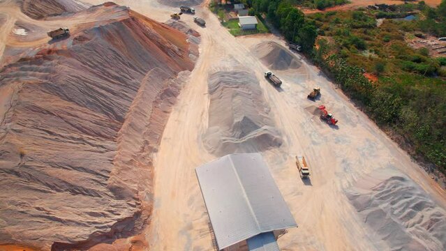 Aerial view from a drone flying over a quarry in the tropics. Southeast asia. Commercial stone industry. Health and respiratory problems. Construction concept. 4K
