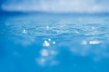 Bright water surface with bokeh and glitter effects.