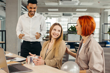 Business team celebrating a colleague's birthday with a cake in the office. Celebrating an employee's birthday at the workplace.