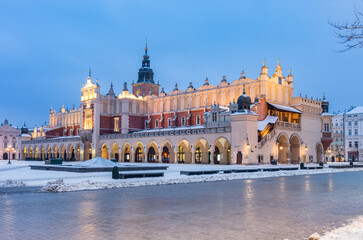 Sukiennice (Cloth Hall) in the Main Square in Krakow, Poland, snowy winter morning
