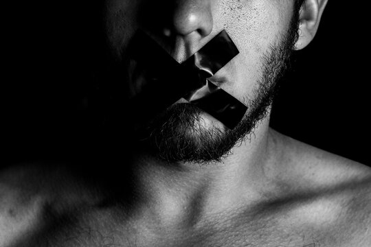 A man who can't speak because his mouth is covered with tape