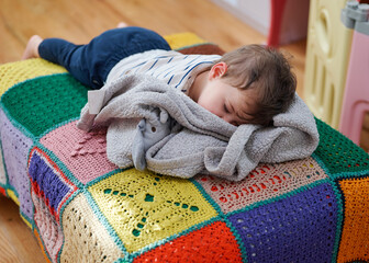 cute little toddler sleeping on a futon
