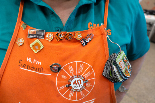 Home Depot clerk with decorated apron pins honoring service. Fergus Falls Minnesota MN USA