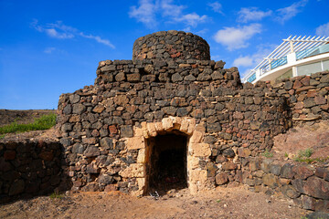 Old lime kilns made out of stone and constituted of a round stepped tower facing the Atlantic Ocean outside the village of El Cotillo on Fuerteventura in the Canary Islands, Spain