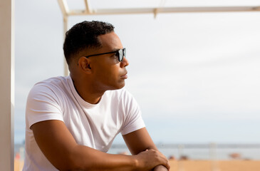 Fototapeta premium Handsome Latino man enjoying day at beach at hotel