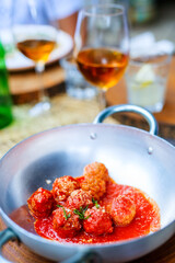Meatballs served with tomato sauce in a pan