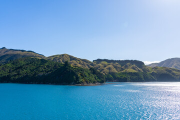 Passing scenic hills and bays while entering Marlborough Sounds by boat