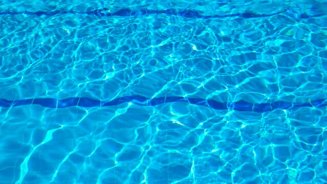 Blue mosaic bottom floor in resort pool. A view of swimming pool with blue mosaic bottom floor during summer hot resort.
