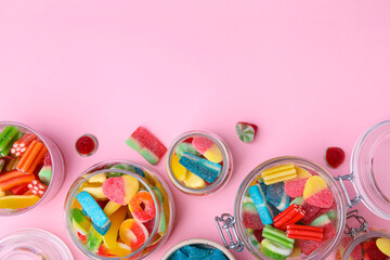 Fototapeta na wymiar Tasty jelly candies in jars on orange background, flat lay. Space for text