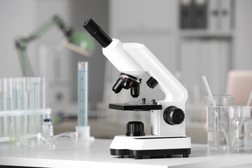 Modern medical microscope on white table in laboratory