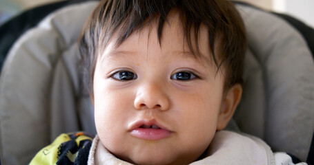 closeup of cute mixed race half asian baby boy smiling and laughing
