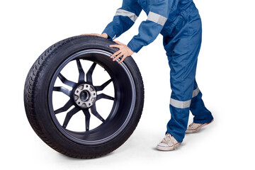 Male mechanic hands pushing a car wheel on studio