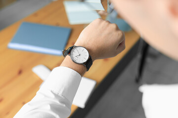 Man checking time in office, closeup. Being late