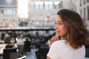 Portrait of happy young woman outdoors on sunny day