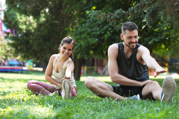 Man and woman doing morning exercise in park