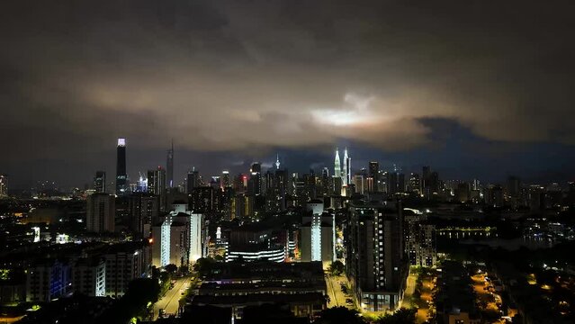 Kuala Lumpur, Malaysia- federal capital of Malaysia cityscape tall buildings moving cloud timelapse changing light sunset, evening, night 