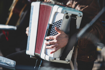 Concert view of accordion player performing on a stage with vocalist and jazz group band orchestra...
