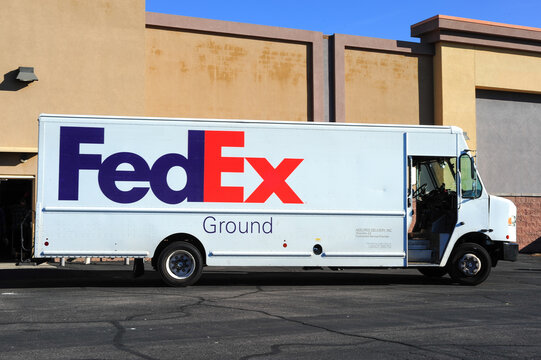 FedEx delivery truck on shopping center parking lot