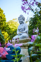 Shrine to Buddha with small statue in gardens