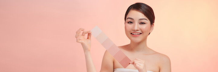 woman face with perfect skin choosing makeup foundation with skin tone palette.