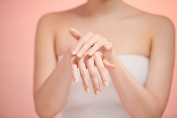 Woman putting cream on hands. Copy space