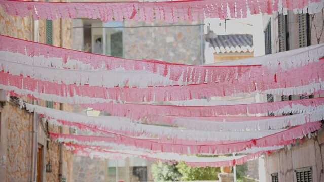 Windy goes through colorfull decorated sidewalks in valldemossa highest village at Mallorca island