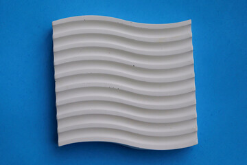 Striped coasters from cement crafts on a blue background, eco-friendly craft business, aesthetic interior items