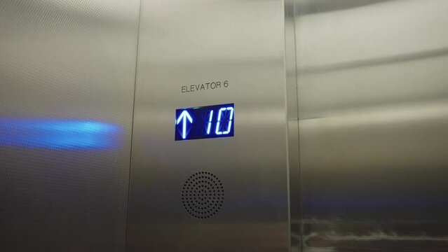 Digital display inside elevator going up building floor