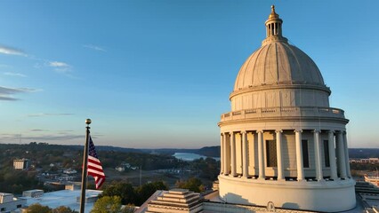 Federal and State government theme. Aerial of USA flag and government building dome.