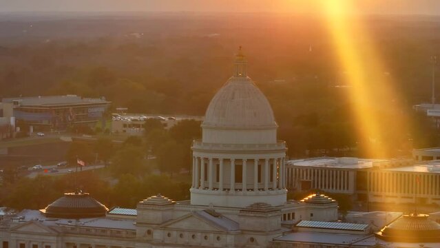 Federal and State Government theme in USA. Long aerial zoom at sunset with unique sunshine effect.