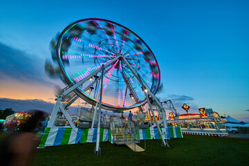 Ferris wheel blurred at carnival county fair in America