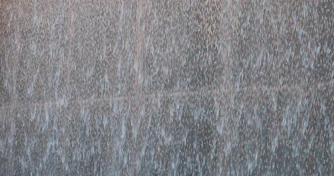 Water Cascades Down Tile Wall