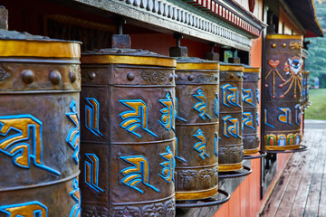 Tibetan Mongolian Buddhist shrine with ornate prayer wheels