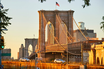 Stunning Brooklyn Bridge in New York City from distance in golden light