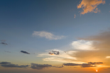 Colofrul clouds brightly illuninated by setting sun on evening sky. Changing cloudscape weather at sunset