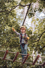 Toddler age. Balance beam and rope bridges. Carefree childhood. Kids boy adventure and travel. Artworks depict games at eco resort which includes flying fox or spider net.
