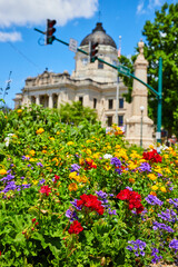 Detail of colorful summer flowers with Bloomington Indiana courthouse in background