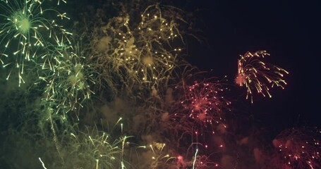 Abstract colored real firework background with big shining glowing fireworks show with bokeh lights in the night sky. 4KDCI