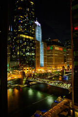Fototapeta na wymiar Night life on Chicago ship canals with bridge and skyscrapers