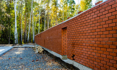 A new long brick wall with an opening.