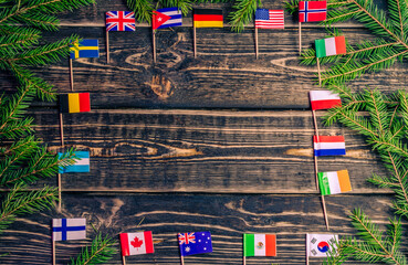 Small flags of the countries of the world on a wooden background with a place to copy.
