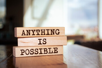 Wooden blocks with words 'Anything is Possible'.