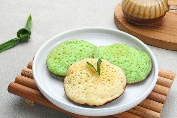 Serabi or Surabi,  Indonesian pancake made of flour, rice flour and coconut milk. Served with palm sugar sauce. Sweet and savory. 
