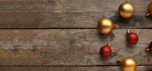 Naklejka na ściany i meble Different Christmas balls on wooden background with space for text