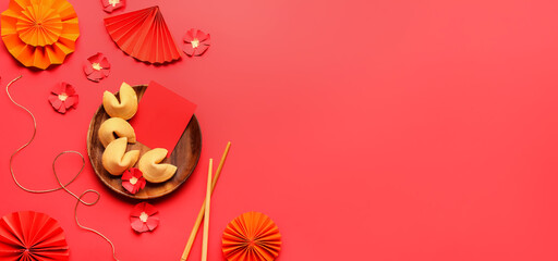 Plate with fortune cookies and Chinese symbols on red background with space for text