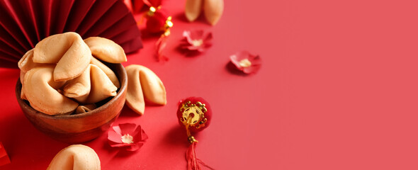 Bowl of tasty fortune cookies and Chinese symbols on red background with space for text