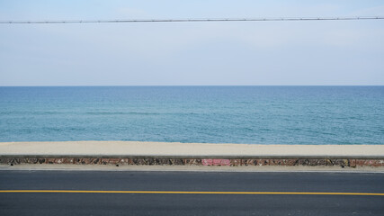 Blue sea and asphalt road